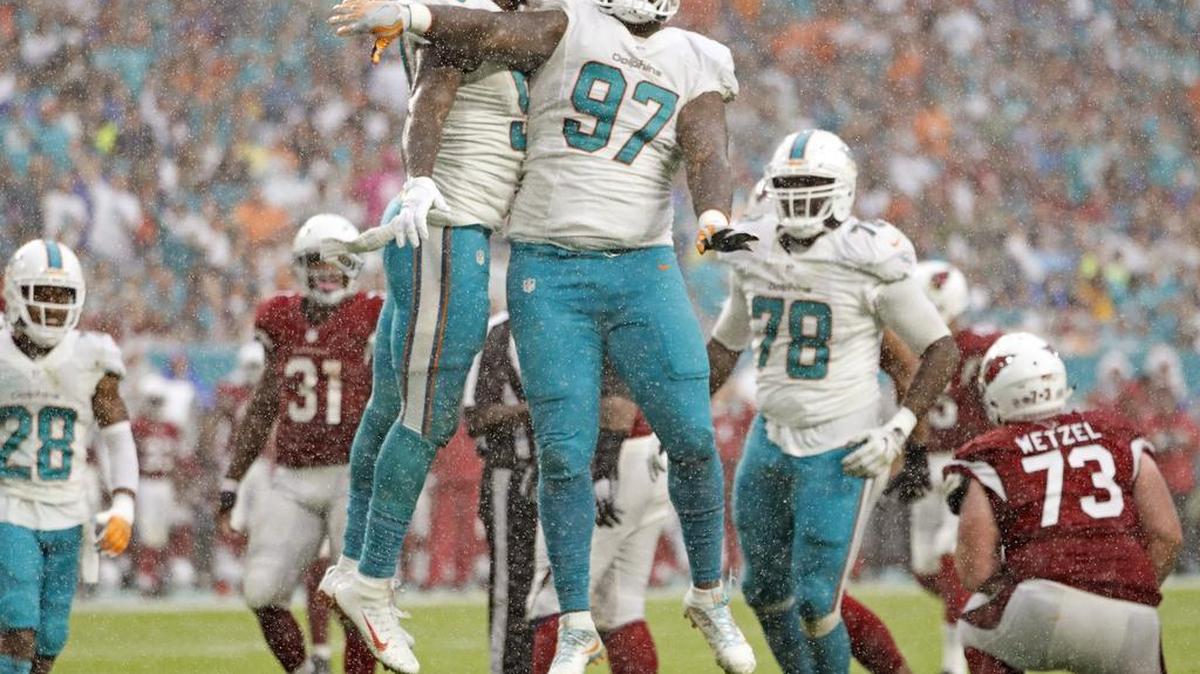 Miami Dolphins defensive end Andre Branch (50) and Miami Dolphins defensive tackle Jordan Phillips (97) celebrate after Branch causes a fumble by Arizona Cardinals quarterback Carson Palmer last season.