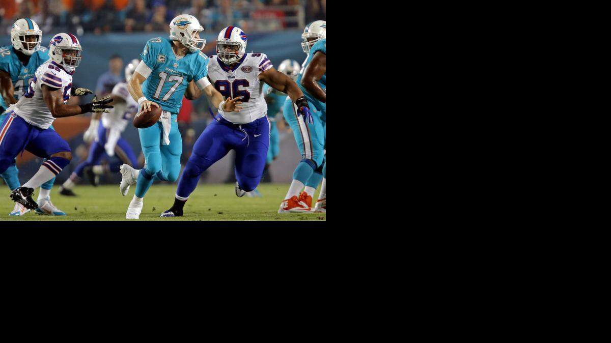 
Miami Dolphins quarterback Ryan Tannehill (17) under pressure from Buffalo Bills defensive tackle Stefan Charles (96) and defensive end Jerry Hughes (55) in the first quarter at Sun Life Stadium in Miami Gardens on Thursday, Nov. 13, 2014.
