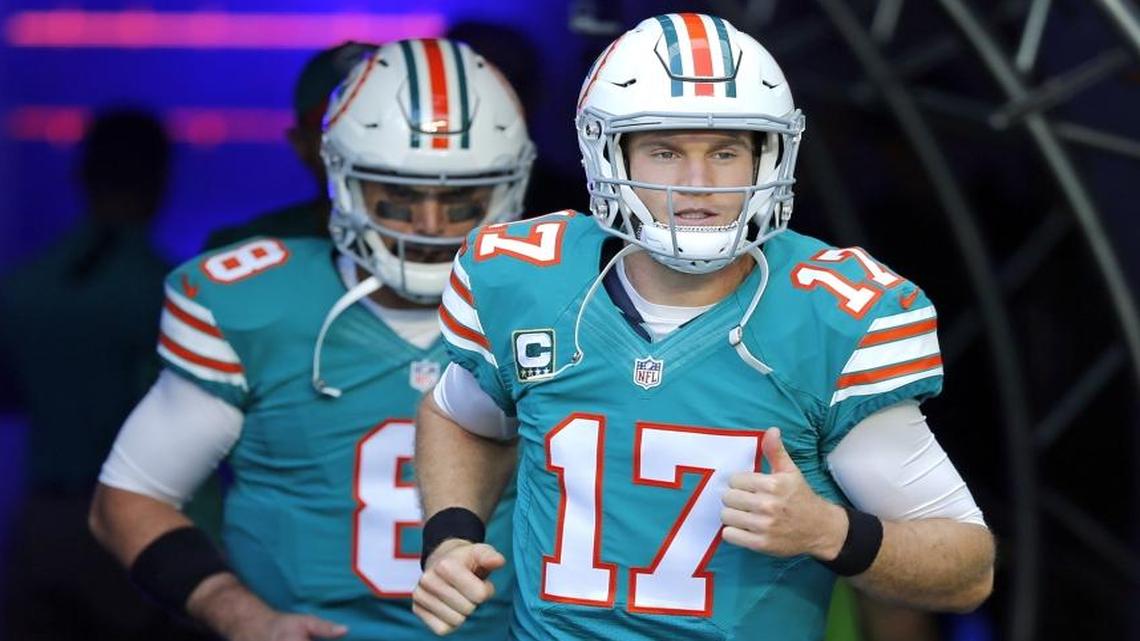 Miami Dolphins quarterback Ryan Tannehill (17) and quarterback Matt Moore (8) rush the field as the Miami Dolphins host the Buffalo Bill at Hard Rock Stadium on Sun., Oct. 23, 2016.