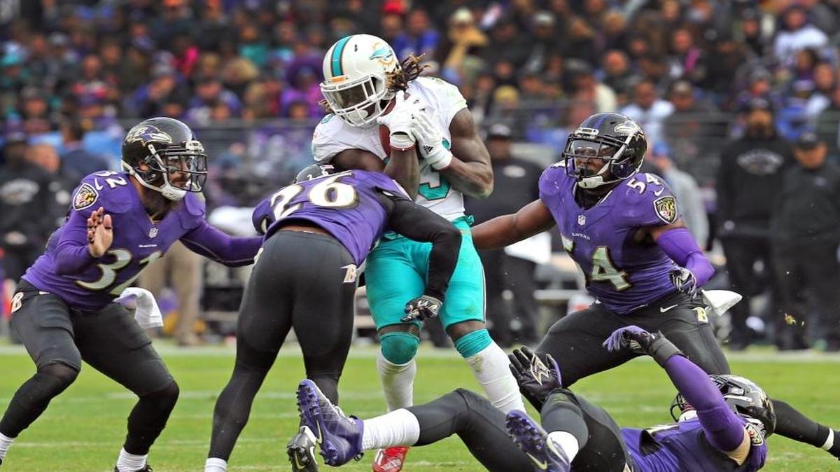 Miami Dolphins Jay Ajayi is surrounded by the Baltimore Ravens defense in the fourth quarter at M&T Bank Stadium in Baltimore, MD, December 4, 2016.
