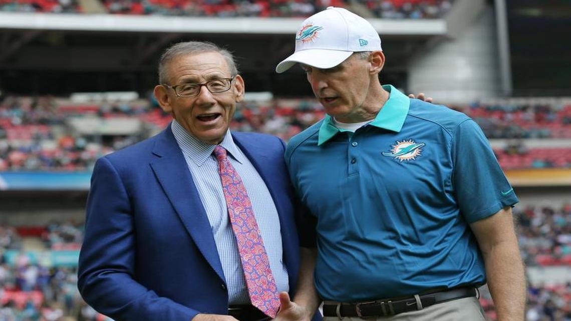 
Miami Dolphins owner Stephen Ross, left, and former Miami Dolphins head coach Joe Philbin shakes hands during warm-up before the NFL football game between the New York Jets and the Miami Dolphins and at Wembley stadium in London, Sunday, Oct. 4, 2015. 
