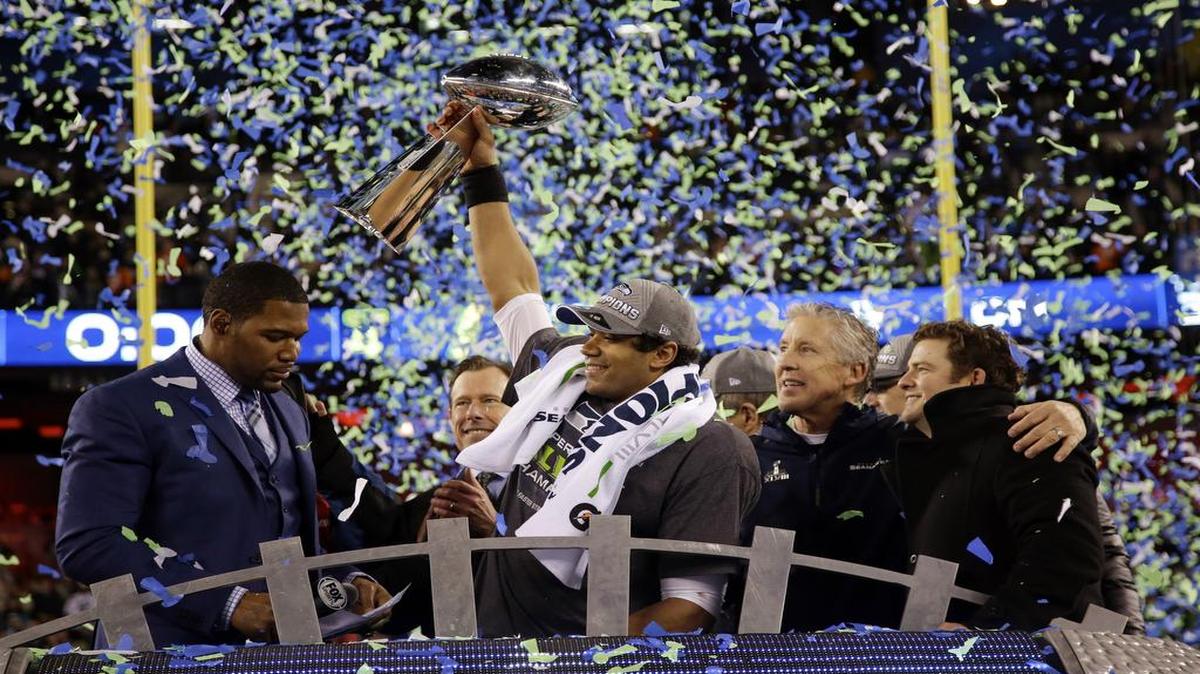 Seattle Seahawks' Russell Wilson (3) raises the Vince Lombardi Trophy after the NFL Super Bowl XLVIII football game against the Denver Broncos, Sunday, Feb. 2, 2014, in East Rutherford, N.J. The Seahawks won 43-8.