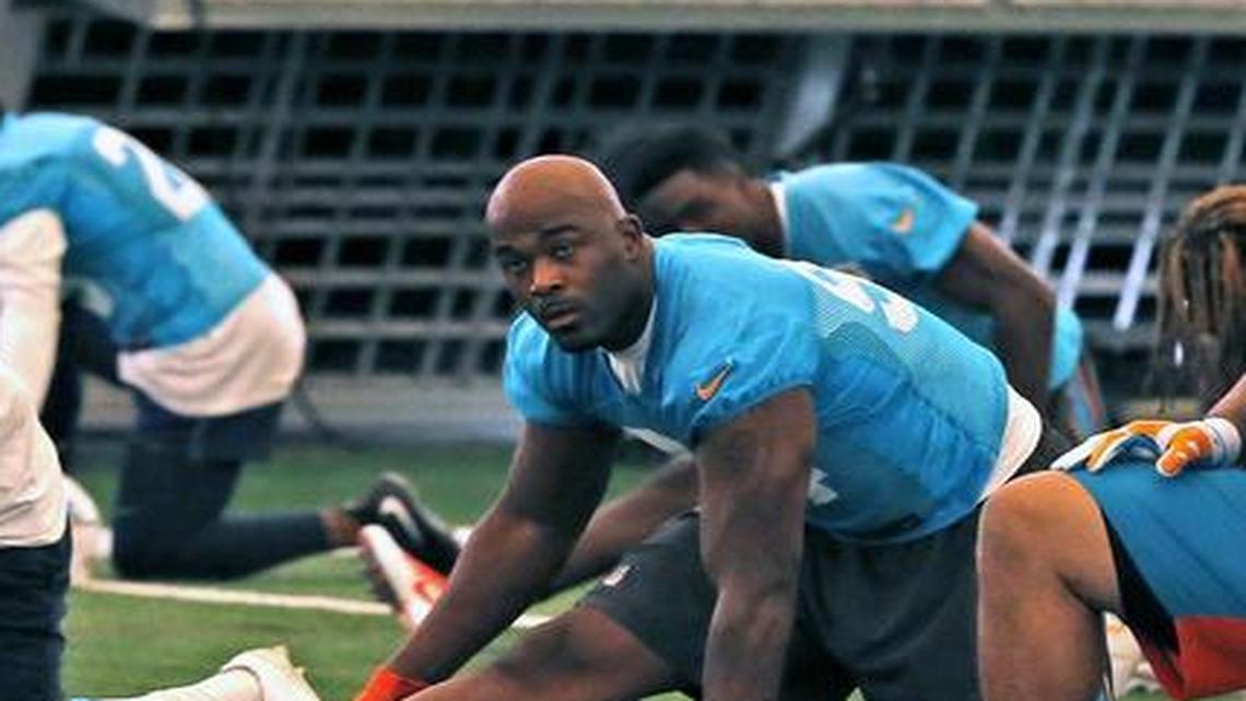 Miami Dolphins’ Mario Williams, left, Ndamukong Suh and Cameron Wake warm up at the Dolphins training facility in Davie in August.