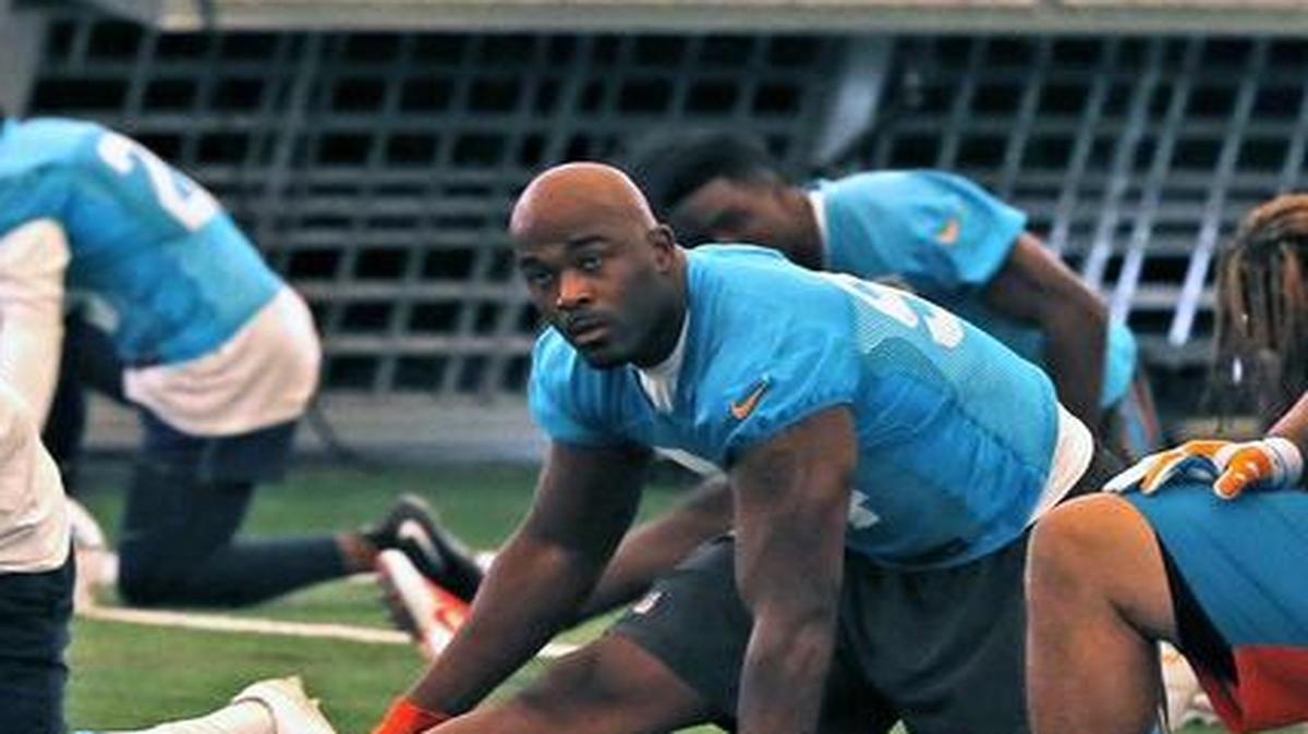 Miami Dolphins’ Mario Williams, left, Ndamukong Suh and Cameron Wake warm up at the Dolphins training facility in Davie in August.