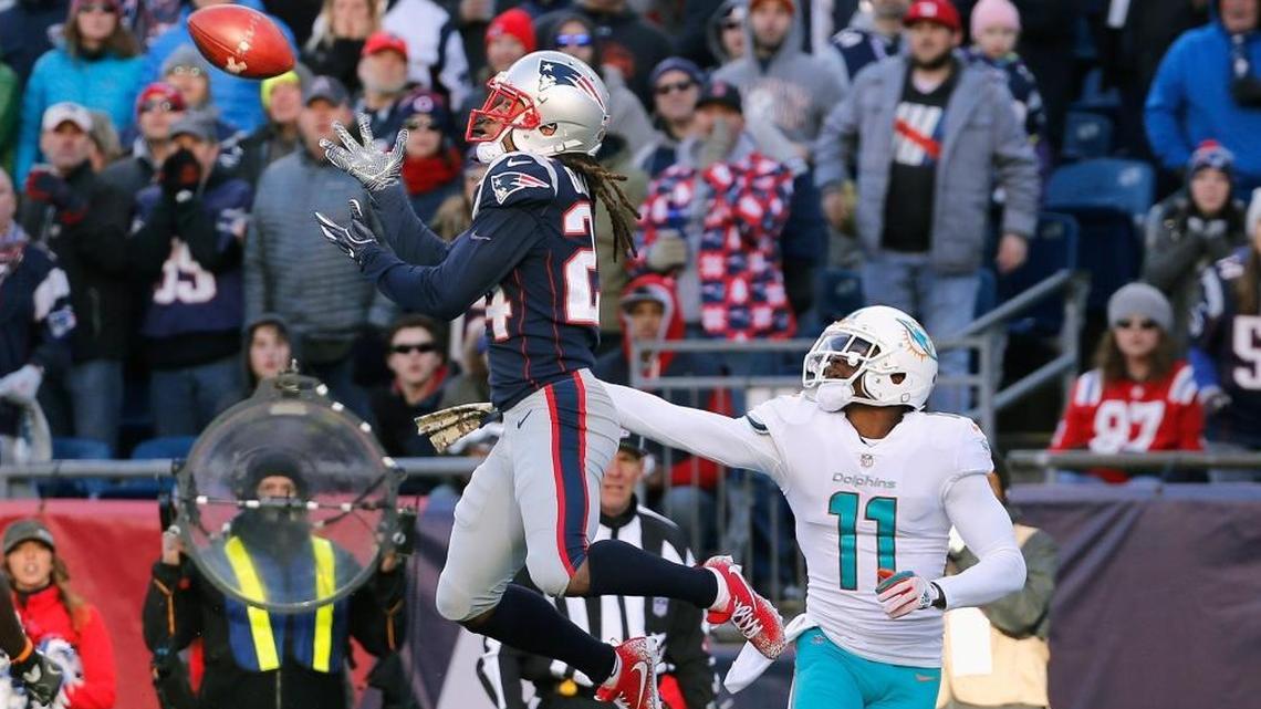 Stephon Gilmore #24 of the New England Patriots intercepts a pass intended for DeVante Parker #11 of the Miami Dolphins during the second quarter of a game at Gillette Stadium on Nov. 26, 2017 in Foxboro, Massachusetts.