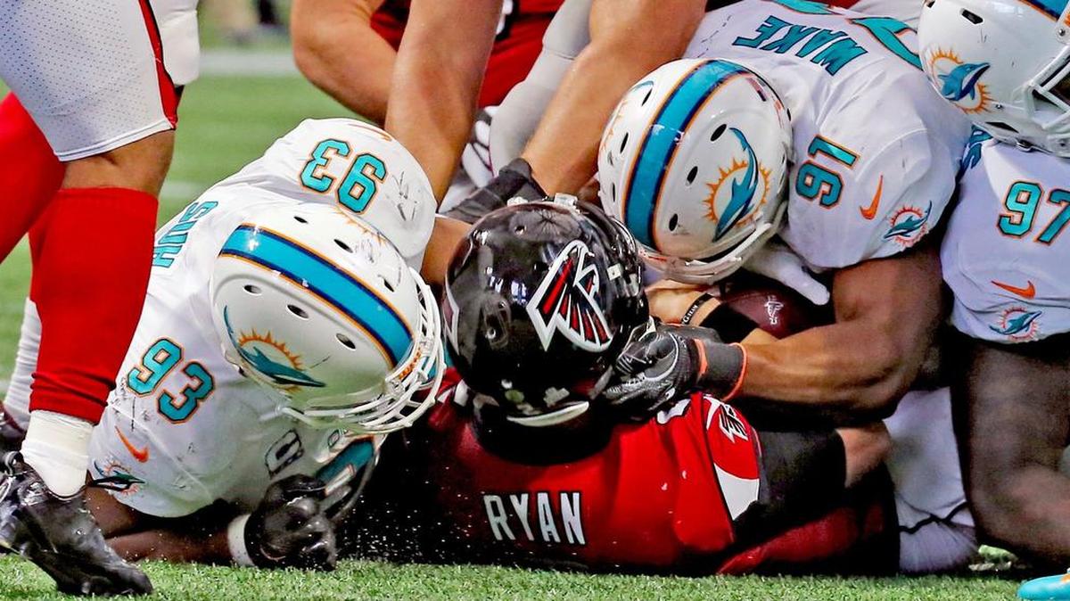 An all too rare meeting at the quarterback this season for Cameron Wake and the Miami Dolphins defensive line.
