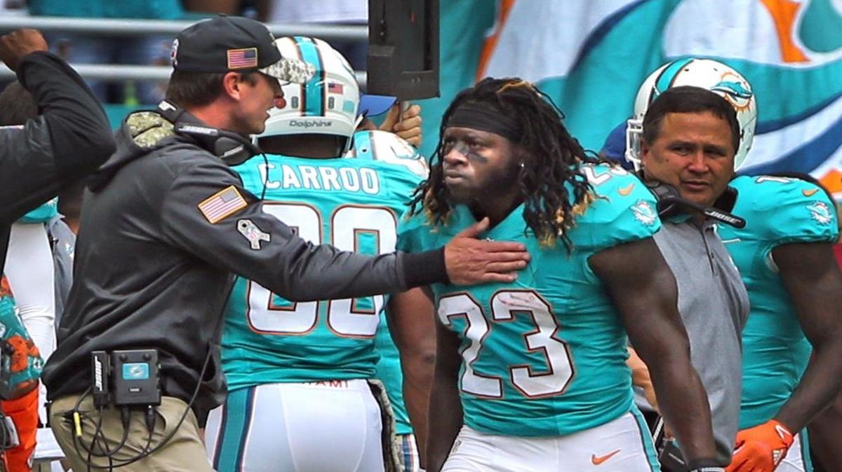 Miami Dolphins coach Adam Gase pats Jay Ajayi on the chest after he scored a first quarter touchdown as they play the New York Jets at Hard Rock Stadium in Miami Gardens, Florida, Nov. 6, 2016.
