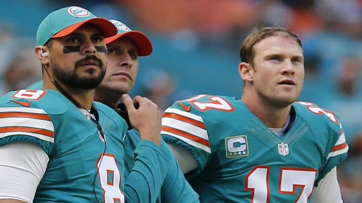 Dolphins quarterbacks Matt Moore, left, and Ryan Tannehill watch the defense with coach Adam Gase as Miami plays the Buffalo Bills at Hard Rock Stadium in October.