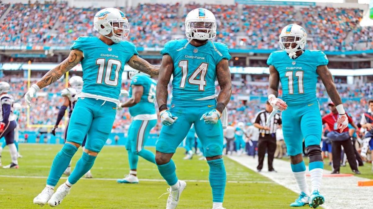 Miami Dolphins wide receiver Jarvis Landry (14) celebrates his touchdown with Miami Dolphins wide receiver Kenny Stills (10) and wide receiver DeVante Parker (11) in the second quarter as the Miami Dolphins host the New England Patriots at Hard Rock Stadium on Sunday, January 1, 2017.
