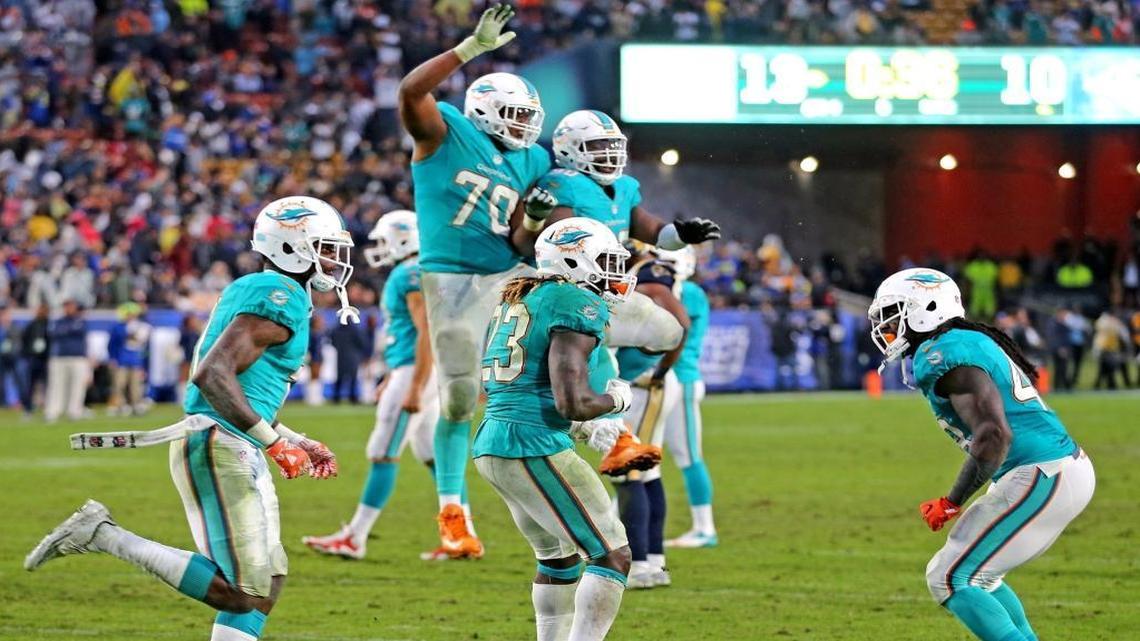 Miami Dolphins DeVante Parker runs off the field after scoring the winning touchdown as teammates celebrate as they defeat the Los Angeles Rams at the Los Angeles Memorial Coliseum in Los Angeles, California, November 20, 2016.