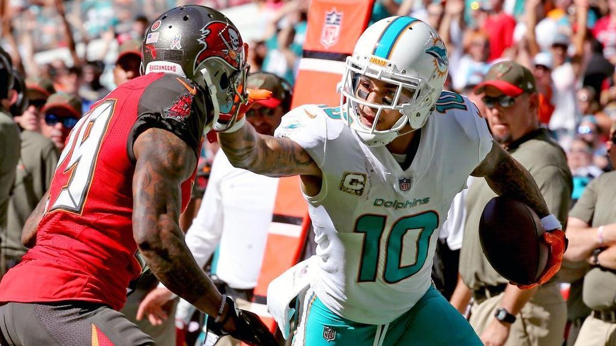 Miami Dolphins Kenny Stills stiff arms Tampa Bay Buccaneers Ryan Smith in the second quarter on Sunday.