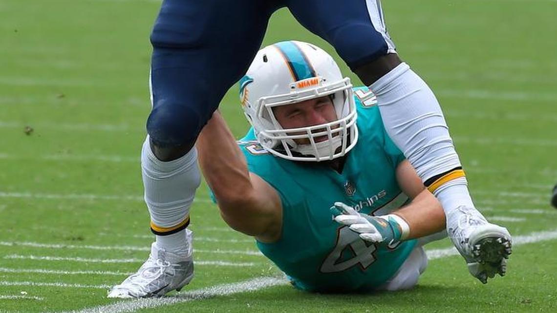 Los Angeles Chargers running back Melvin Gordon, top, escapes a tackle by Miami Dolphins linebacker Mike Hull during an NFL football game, Sunday, Sept. 17, 2017, in Carson, Calif.