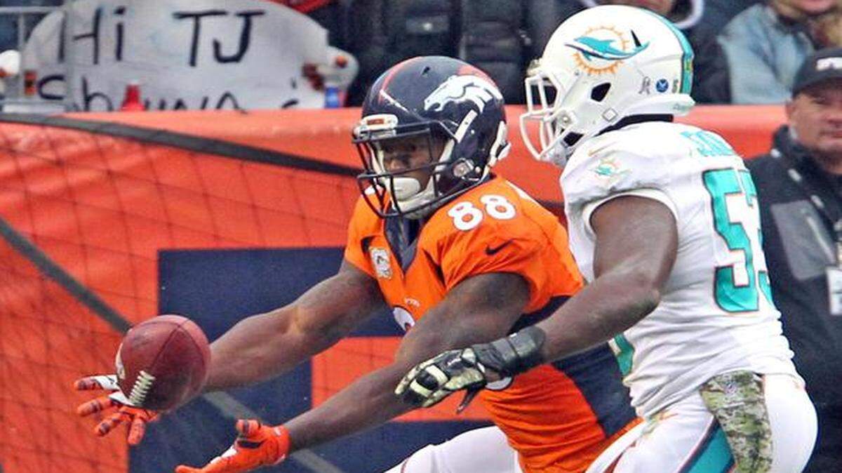 
Miami Dolphins defender Jelani Jenkins fails to stop Denver Broncos receiver Demaryius Thomas from scoring with a catch in the second quarter at Sports Authority Field at Mile High in Denver, Colorado, Nov. 23, 2014.
