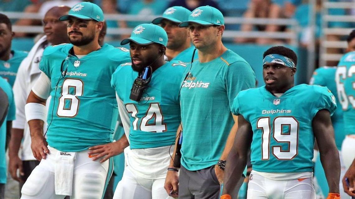 Dolphins Matt Moore (8), Jarvis Landry (14), new quarterback Jay Cutler, and Jakeem Grant (19), on the sidelines as the Miami Dolphins play the Atlanta Falcons in the first preseason game at the Hard Rock Stadium in Miami Gardens, Florida, Aug. 10, 2017.