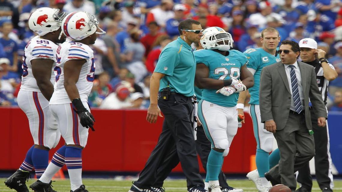 Former Dolphins athletic trainer Ryan Grove, in the glasses, attended to scores of injuries during his four seasons with the team.
