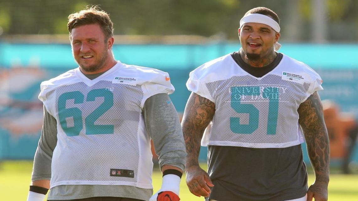 Miami Dolphins lineman Ted Larsen (62) and Mike Pouncey (51) at the start of training camp. Both are nursing injuries.