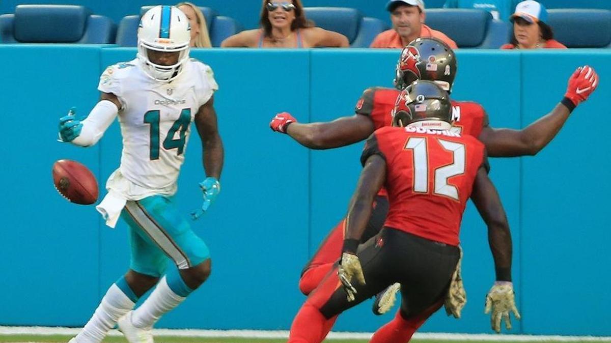 Miami Dolphins wide receiver Jarvis Landry (14) fumbles the ball after a multi lateral passing play at the end of the fourth quarter. Tampa Bay Buccaneers outside linebacker Adarius Glanton (53) picks up the fumble in the end zone for a touchdown to seal the game as the Miami Dolphins host the Tampa Bay Buccaneers at Hard Rock Stadium on Sun., Nov. 19, 2017.