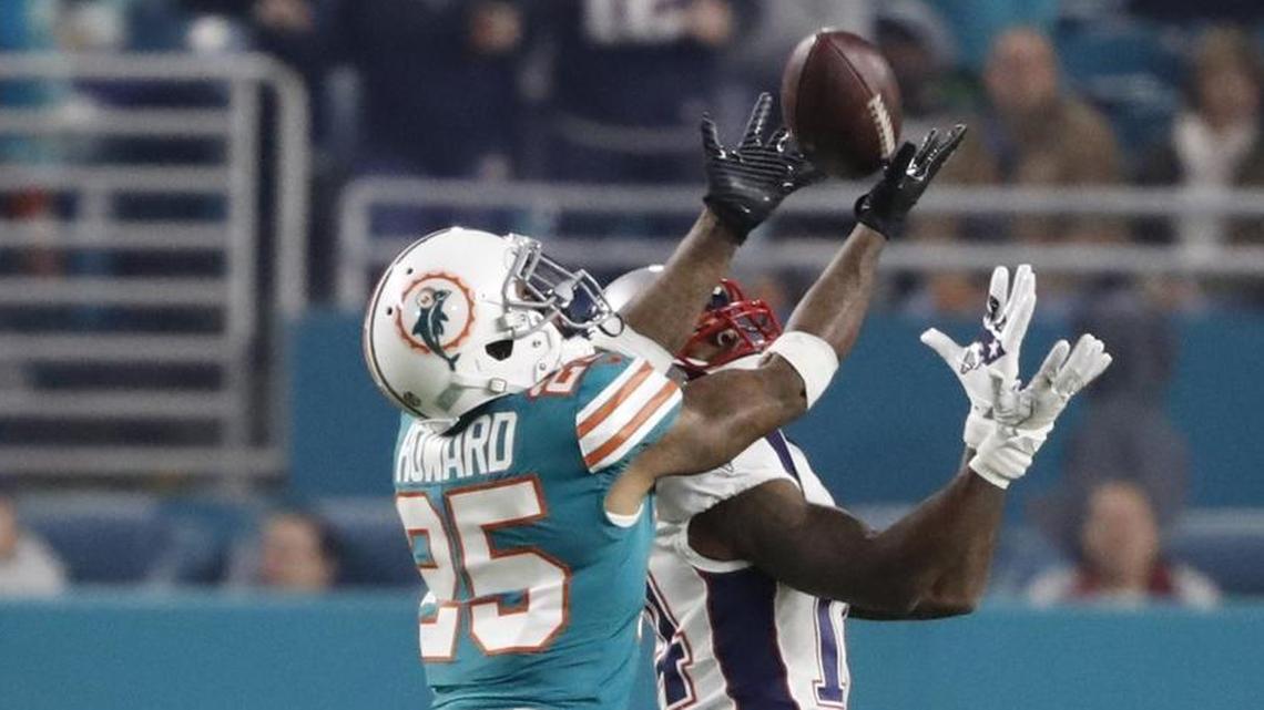 Miami Dolphins cornerback Xavien Howard (25) intercepts the ball intended for New England Patriots wide receiver Brandin Cooks (14) in the third quarter as the Miami Dolphins host the New England Patriots at hard Rock Stadium on Monday, Dec. 11, 2017.