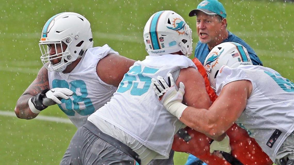 Miami Dolphins offensive line coach Chris Foerster gives instructions to Miami Dolphins guard Isaac Asiata during OTAs last spring.