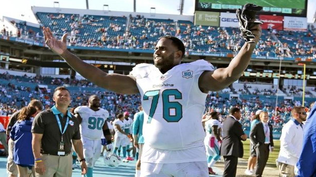 Miami Dolphins offensive tackle Branden Albert (76) motivates the fans as the fourth quarter winds down as Miami hosts the Houston Texans at Sun Life Stadium on October 25, 2015.