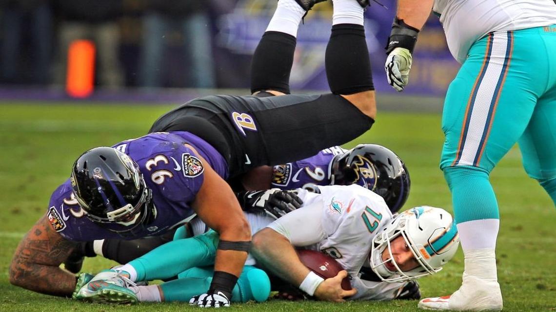 Miami Dolphins quarterback Ryan Tannehill is sacked by Baltimore Ravens Lawrence Guy (93), in the fourth quarter as Fins center Anthony Steen (65), looks down at M&T Bank Stadium in Baltimore, MD, December 4, 2016.