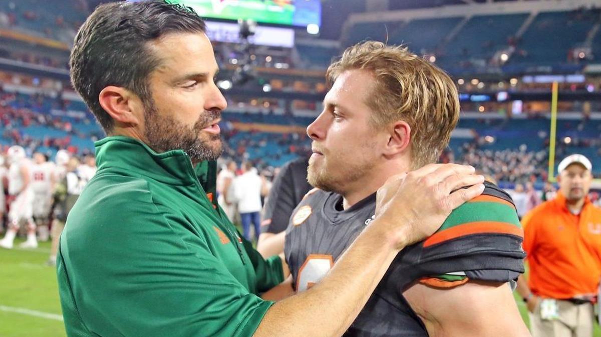 UM defensive coordinator Manny Diaz embraces receiver Braxton Berrios after the Dec. 30 Orange Bowl. Berrios is planning for an NFL career.