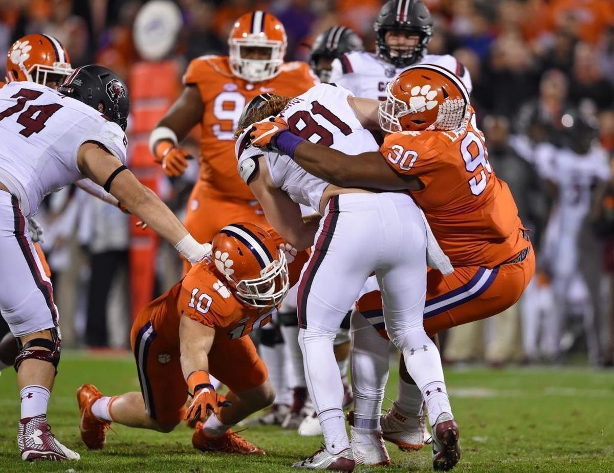 Clemson's Jalen Williams (30) and Ben Boulware (10) tackle South Carolina's Hayden Hurst during the first half of a 56-7 Clemson win last November. Hurst, one of the top tight ends in the NFL Draft, is visiting Dolphins headquarters next week.