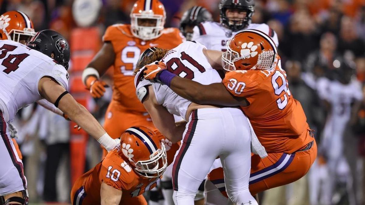 Clemson's Jalen Williams (30) and Ben Boulware (10) tackle South Carolina's Hayden Hurst during the first half of a 56-7 Clemson win last November. Hurst, one of the top tight ends in the NFL Draft, is visiting Dolphins headquarters next week.