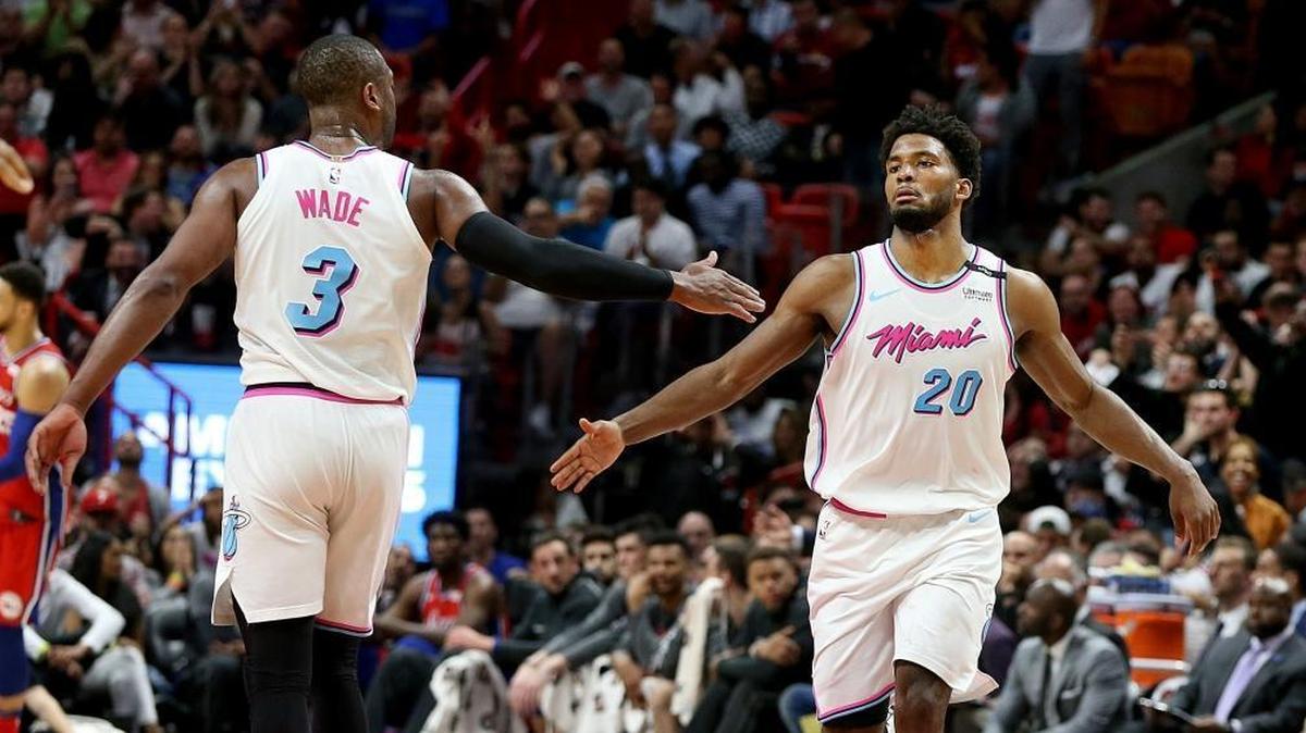 Heat guard Dwyane Wade and forward Justise Winslow celebrate as they lead in the fourth quarter of the Miami Heat and Philadelphia 76ers game at AmericanAirlines Arena in Miami on March 8, 2018.