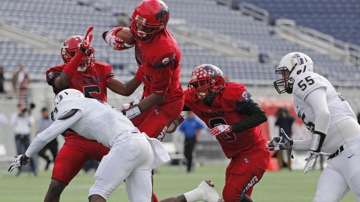 Champagnat's Gregory Rousseau (5) advances a blocked punt as Champagnat plays Jacksonville University Christian.
