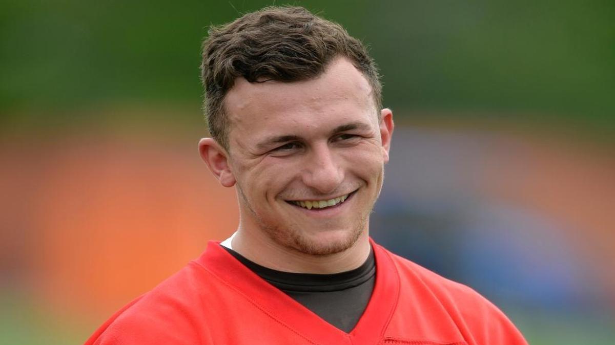 Then-Cleveland Browns quarterback Johnny Manziel smiles during an NFL football organized team activity, in Berea, Ohio. Johnny Manziel will be in Houston ahead of the Super Bowl to give fans a chance to take a photo with the 2012 Heisman trophy winner at a price.