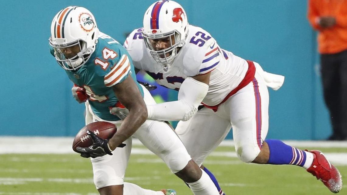 Miami Dolphins wide receiver Jarvis Landry (14) is taken down by Buffalo Bills middle linebacker Preston Brown (52) during the Dolphins’ finale against the Bills on Dec. 31. Landry is an impending unrestricted free agent and the sides aren’t close on a new deal.