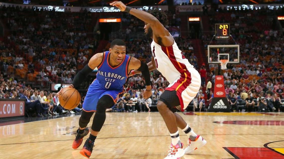 Oklahoma City Thunder guard Russell Westbrook drives against Miami Heat forward Justise Winslow during the fourth quarter of an NBA basketball game at AmericanAirlines Arena in Miami on Tuesday, December 27, 2016.