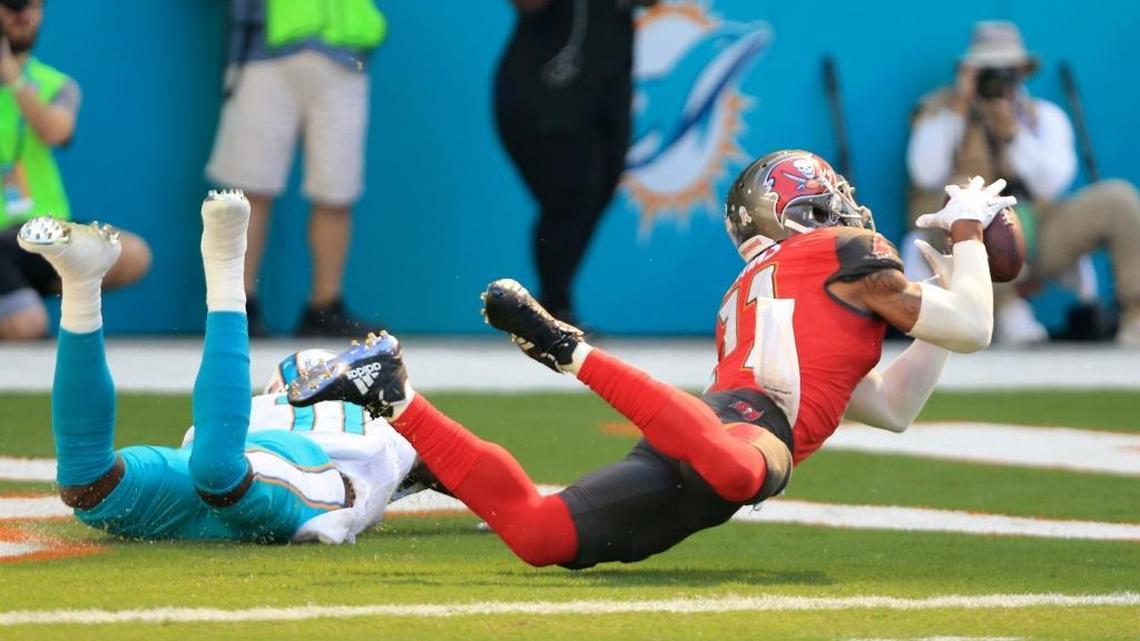Tampa Bay Buccaneers strong safety Justin Evans (21) intercepts the ball intended for Miami Dolphins wide receiver DeVante Parker (11) in the end zone in the Dolphins-Tampa Bay game on Nov. 19.