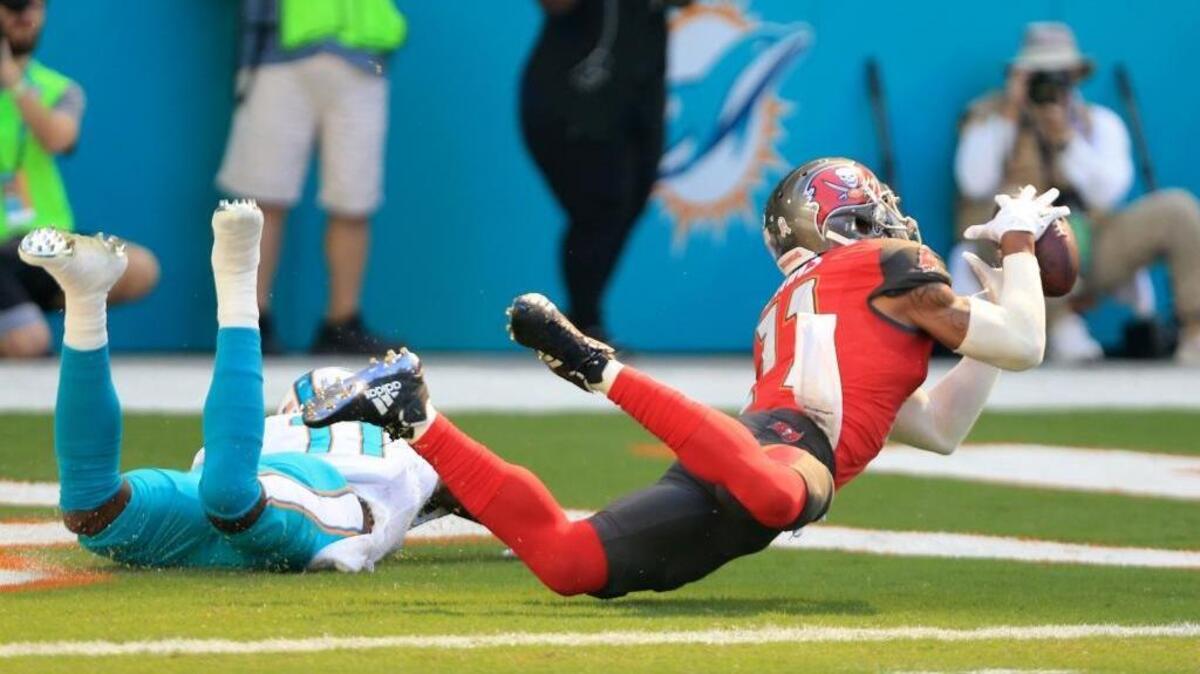 Tampa Bay Buccaneers strong safety Justin Evans (21) intercepts the ball intended for Miami Dolphins wide receiver DeVante Parker (11) in the end zone in the Dolphins-Tampa Bay game on Nov. 19.