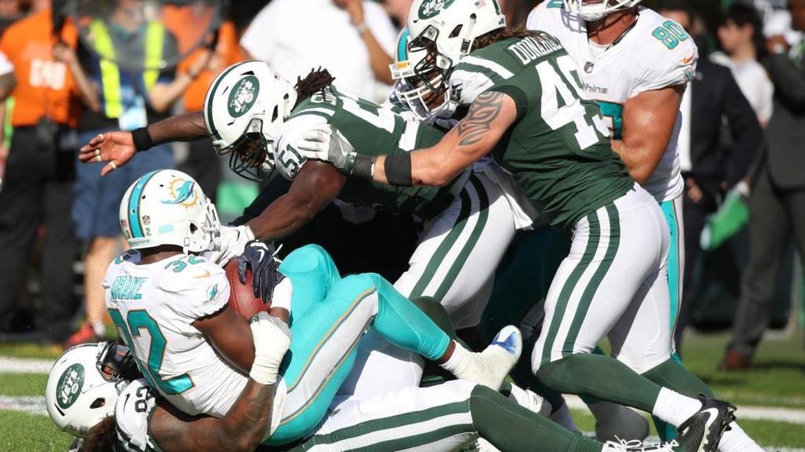 New York Jets defensive end Leonard Williams (92) and teammates take down Miami Dolphins running back Kenyan Drake (32) in the fourth quarter as the New York Jets host the Miami Dolphins at Met Life Stadium on Sunday, September 24, 2017.