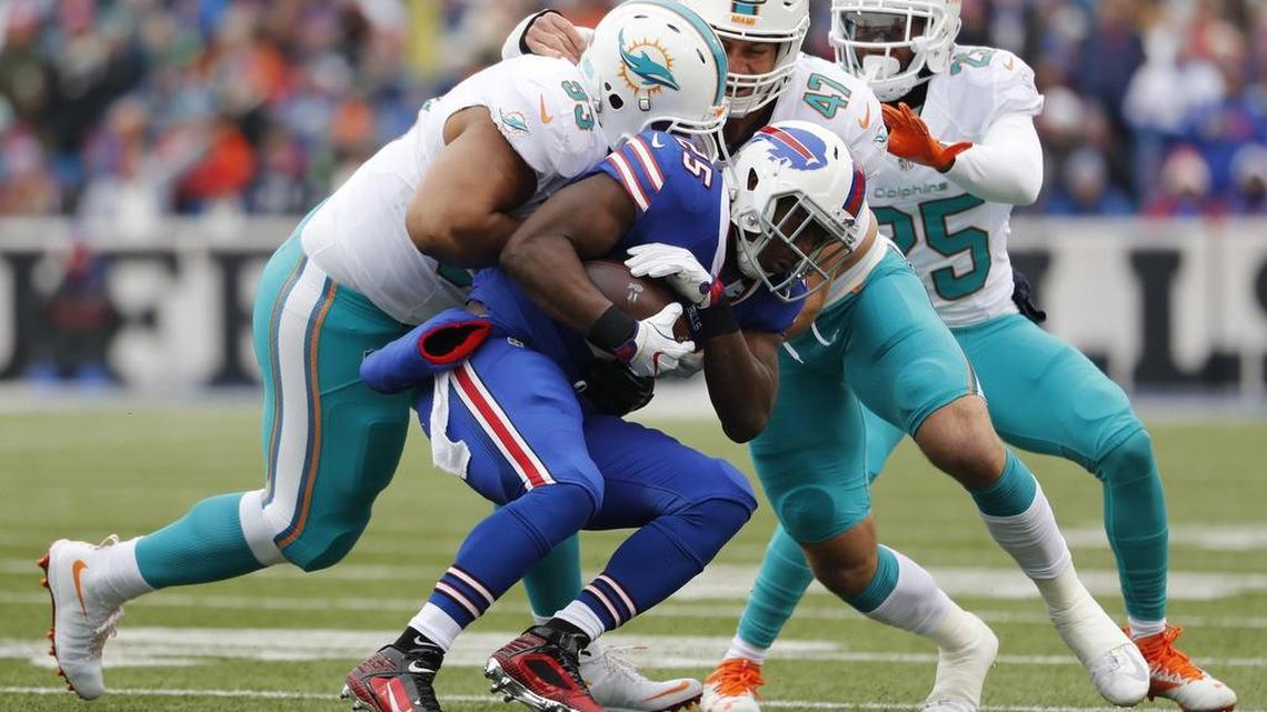 Miami Dolphins defensive tackle Ndamukong Suh (93) and Miami Dolphins middle linebacker Kiko Alonso (47) take down Buffalo Bills running back LeSean McCoy (25) in the first quarter as the Buffalo Bills host the Miami Dolphins at New Era Field in Orchard Park, NY on Saturday, December 24, 2016.