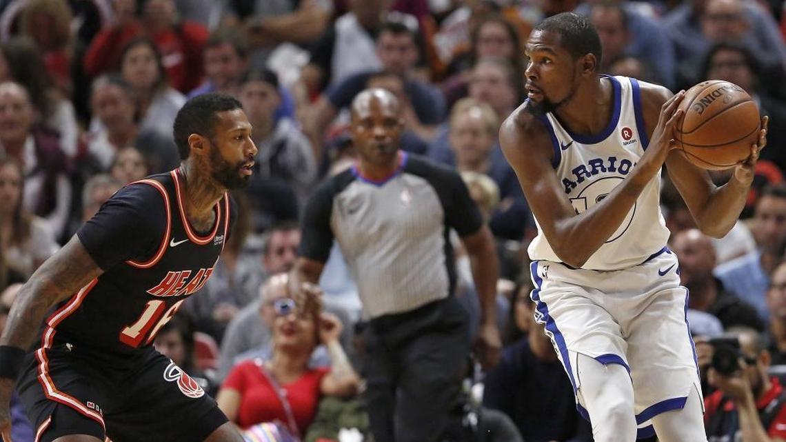 Golden State Warriors forward Kevin Durant drives against Miami Heat forward James Johnson during the first quarter of an NBA basketball game at the AmericanAirlines Arena in Miami on Sun., Dec. 3, 2017.