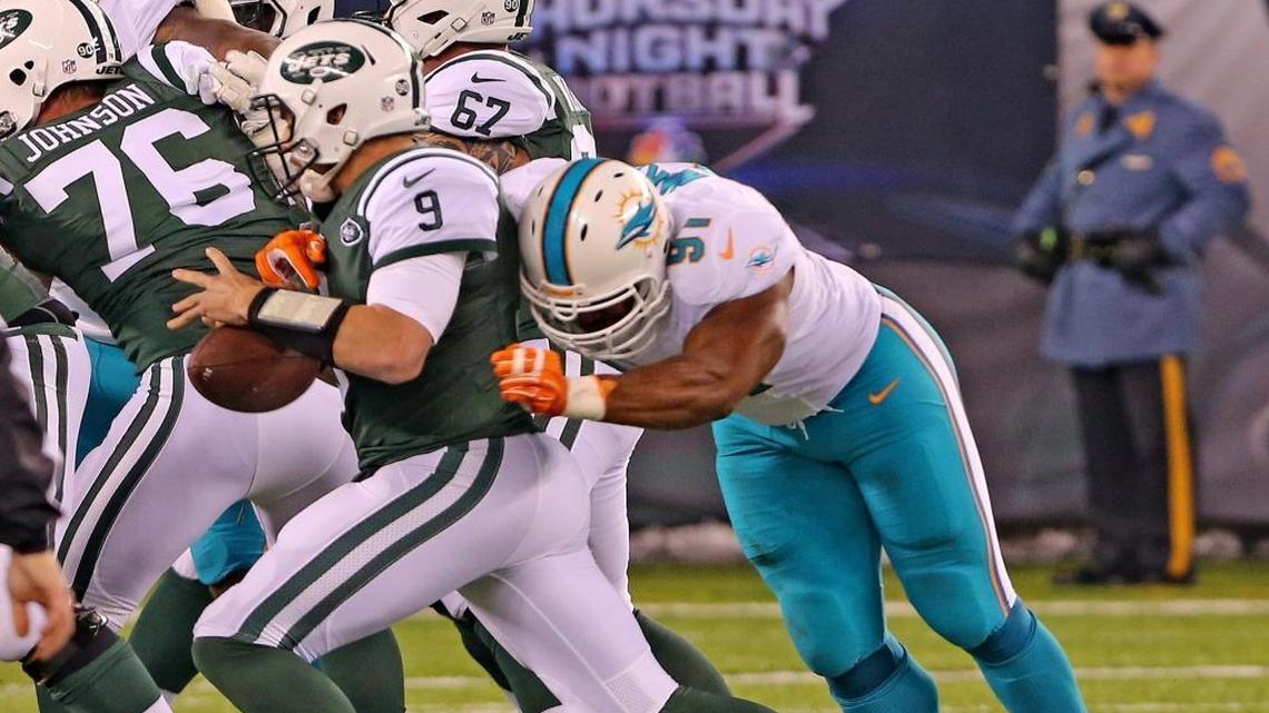 Miami Dolphins Cameron Wake forces a fumble on New York Jets quarterback Bryce Petty in the first quarter at MetLife Stadium in East Rutherford, New Jersey on Sat., Dec. 17, 2016.