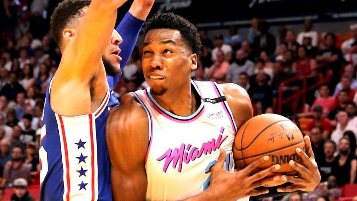 Miami Heat center Hassan Whiteside looks to the basket in Tuesday’s game, as Philadelphia 76ers guard Ben Simmons offers resistance. Whiteside has averaged 15 points, 11.7 rebounds and 2.3 blocks in three games since the All-Star break and also contributed in ways not measured statistically.