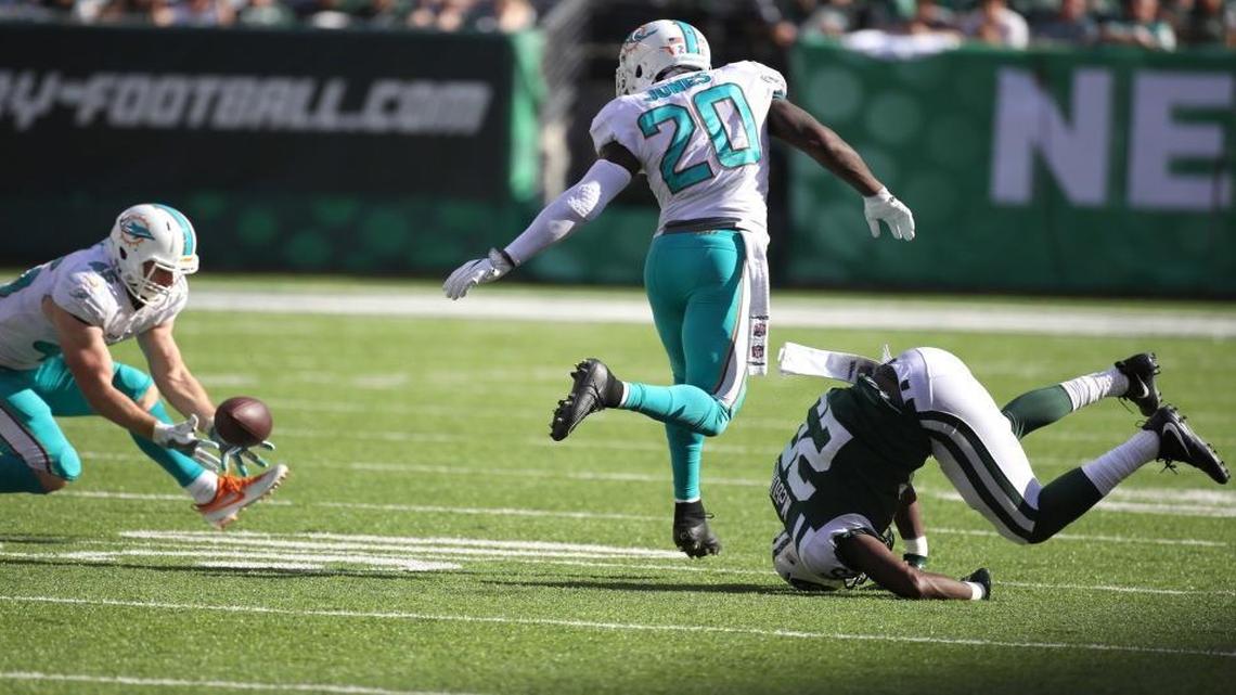 Miami Dolphins cornerback Byron Maxwell (41) causes the Jets running back Elijah McGuire (25) to fumble and outside linebacker Mike Hull (45) picks it up for a turnover in the fourth quarter as the New York Jets host the Miami Dolphins at Met Life Stadium on Sunday, Sept. 24, 2017.