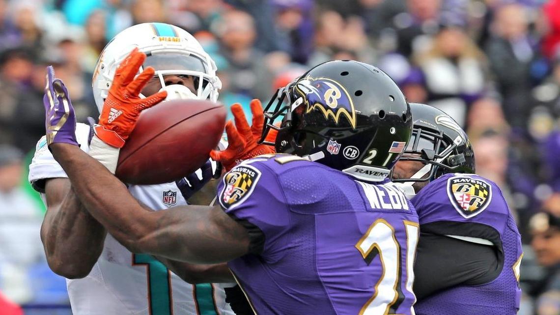 Miami Dolphins DeVante Parker can't grab the ball as Baltimore Ravens Lardarius Webb intercepts the ball in the endzone in the second quarter at M&T Bank Stadium in Baltimore, MD, Dec. 4, 2016.