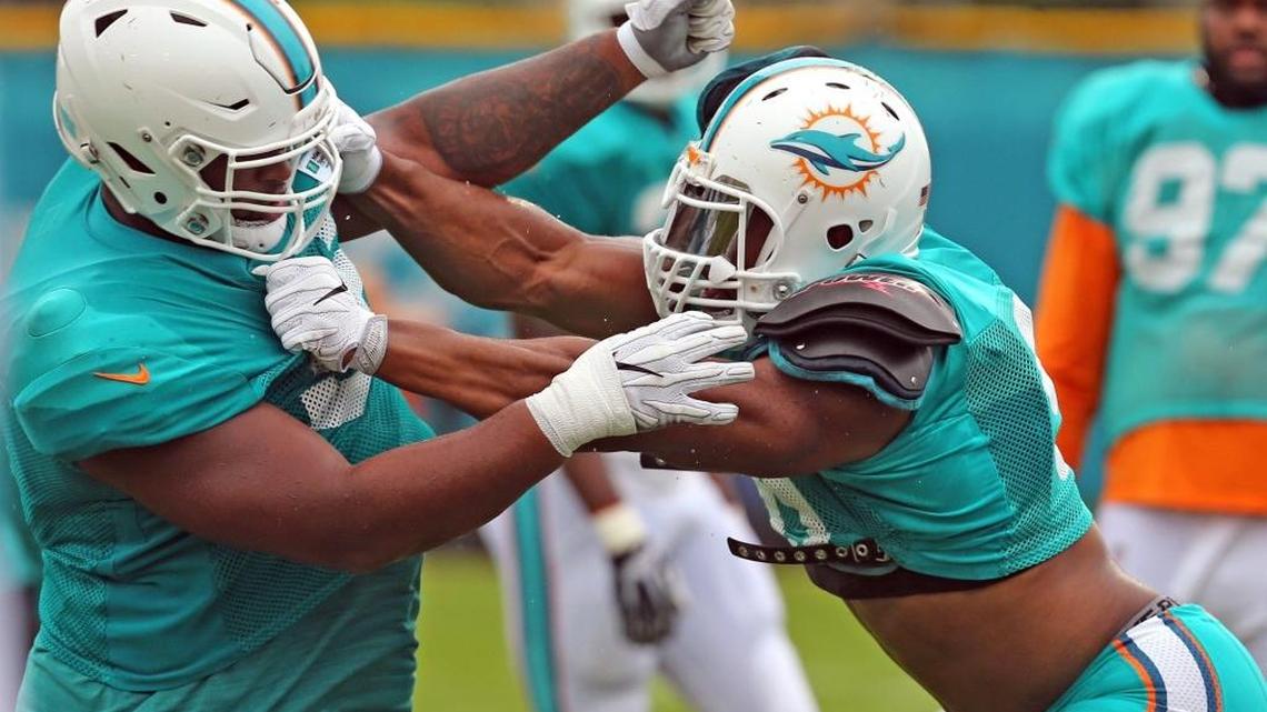 Miami Dolphins Davon Godchaux 56, and Cameron Wake 91, runs a defensive lineman drill during training camp at the Miami Dolphins training facility in Davie, Fl, July 31, 2017.