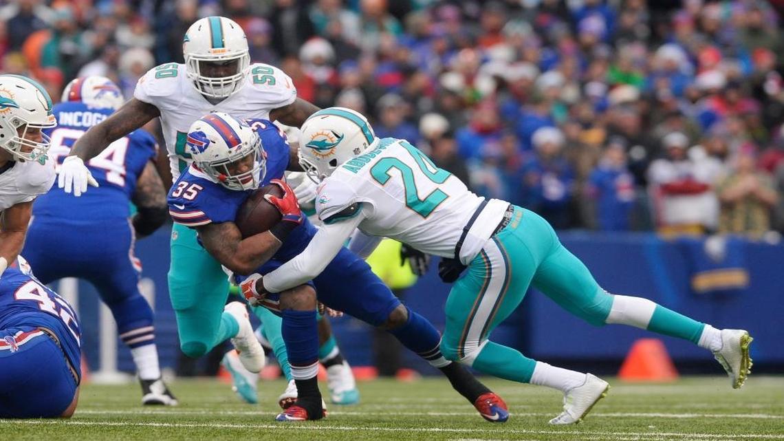 Buffalo Bills running back Mike Gillislee (35) is tackled by Miami Dolphins' Isa Abdul-Quddus (24) during the first half of an NFL football game Sat., Dec. 24, 2016, in Orchard Park, N.Y.