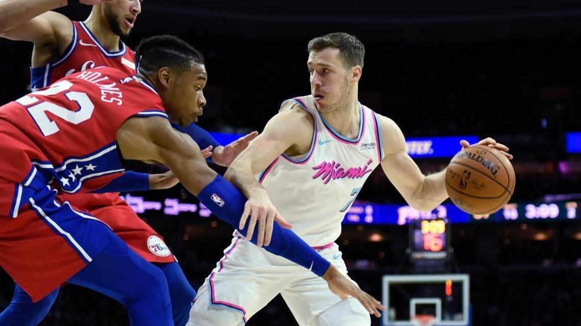Miami Heat guard Goran Dragic (7) breaks away from Philadelphia 76ers’ Richaun Holmes (22) and Ben Simmons in Philadelphia’s 104-102 win against the Heat on Wednesday.