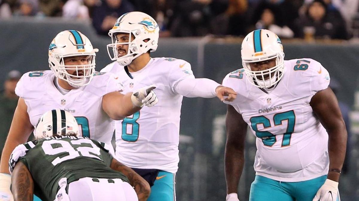 Miami Dolphins center Kraig Urbik 60, quarterback Matt Moore 8, and Laremy Tunsil 67, set the line as they play the New York Jets at MetLife Stadium in East Rutherford, New Jersey, December 17, 2016.