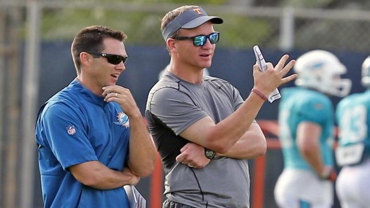 Former Dolphins director of player personnel Joe Schoen (now Bills assistant GM) stands with former NFL quarterback Peyton Manning as the Fins practice at the Miami Dolphins training facility in Davie, Florida, Aug. 1, 2016.