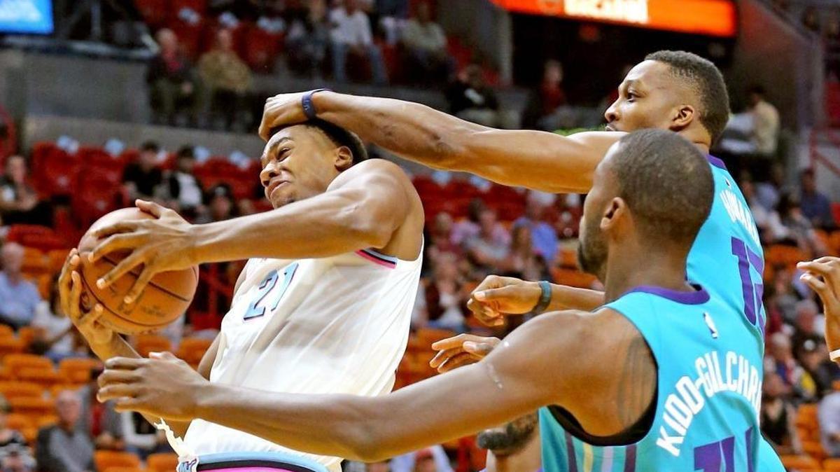 Miami Heat center Hassan Whiteside (21) is fouled by Charlotte Hornets center Dwight Howard (12) in the first quarter of a game last Saturday. Whiteside has been very good in some games, less so in others.