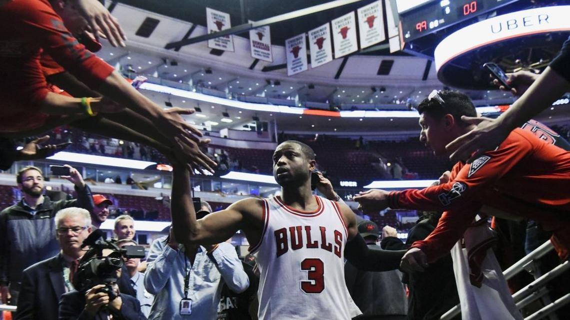 In his first game with the team, Chicago Bulls guard Dwyane Wade (3) greets fans after an NBA basketball game against the Boston Celtics Thursday, Oct. 27, 2016, in Chicago. The Chicago Bulls won 105-99.