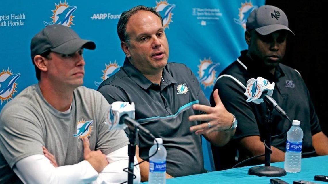Miami Dolphins Mike Tannenbaum, vice president of football operations, and coach Adam Gase (left) and GM Chris Greer (right), talk to the media at a January news conference.